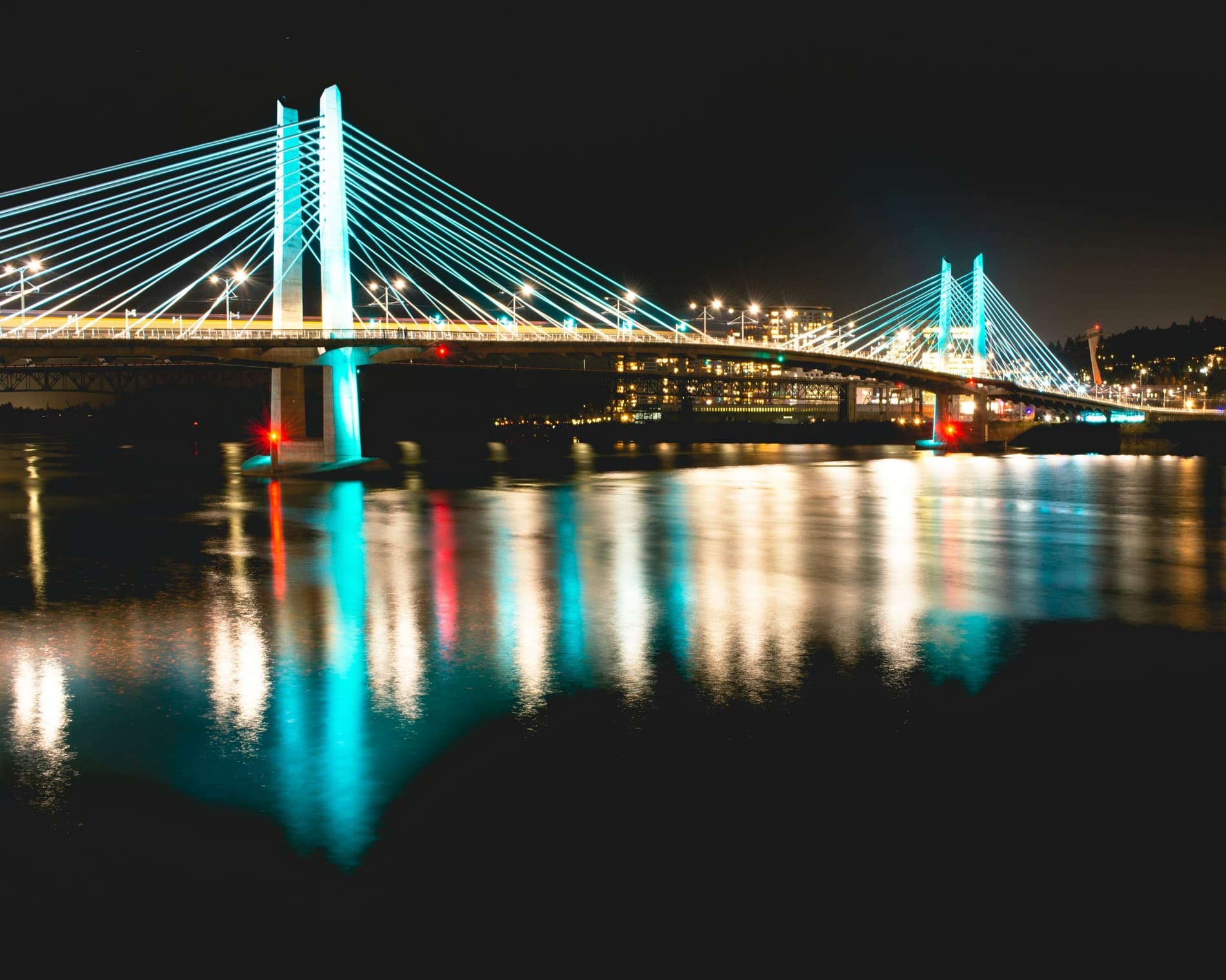 Tilikum Crossing lit up over the Willamette at night