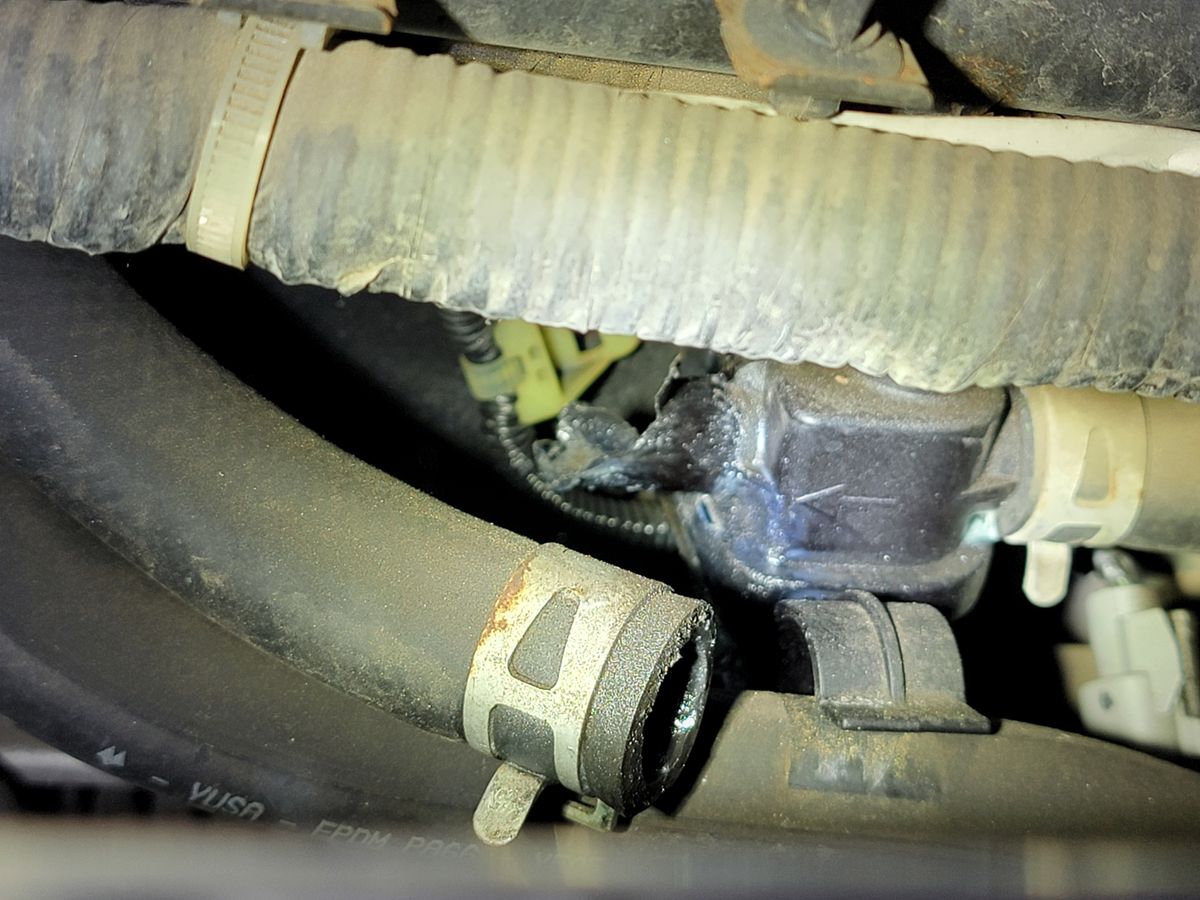 Failed heater control valve on a 2005 Honda Element showing the broken nipple where coolant escaped