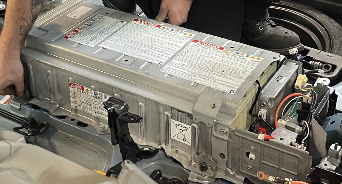 Toyota Prius hybrid battery top cover showing multiple white labels, typical of a newer OEM replacement pack